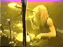 a man playing drums in front of a microphone