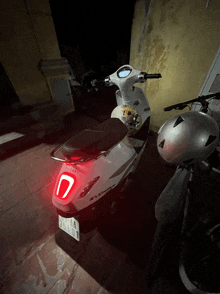 a white scooter with a license plate that says 25101