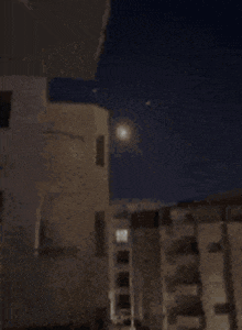 a person is standing in a dark room with a light shining through the ceiling .