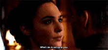 a woman is talking to a man in a dark room .