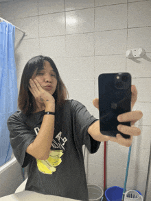 a person taking a selfie with a phone that has the word apple on it