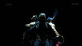 a man in a blue hat is standing next to another man in a dark room with thriller tv written on the bottom of the screen