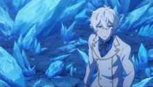 a man in a white suit stands in front of a blue background of ice crystals