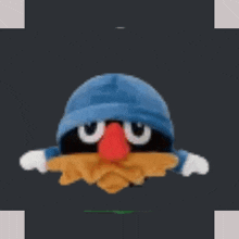 a stuffed animal with a blue hat and a red nose is floating in the air .