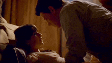 a man is touching a woman 's breast while laying on a couch