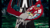 a person is holding a red object that looks like a sword in their hands .