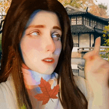 a painting of a woman with a maple leaf around her neck
