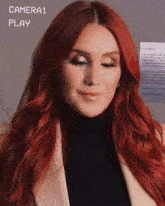 a woman with red hair is in front of a camera that says camera1 play