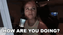 a woman is sitting in front of a microphone with the words `` how are you doing ? ''