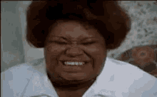 a close up of a woman making a funny face with her mouth open .