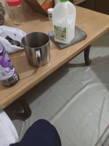 a bottle of aquafina water sits on a wooden table