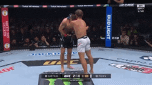 two men are fighting in a boxing ring with bud light advertisements on the side