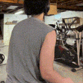 a man wearing headphones is sitting in front of an elliptical