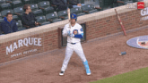 a baseball player holding a bat in front of a marquee sports network banner