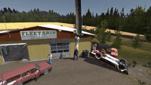 a fleetarin sign hangs above a garage with cars parked in front of it