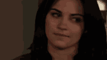 a close up of a woman 's face making a surprised face .