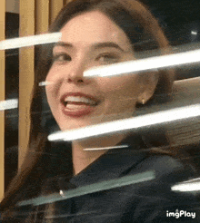 a close up of a woman 's face with a smile on her face .