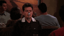 a man has a spoon sticking out of his mouth