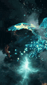a blue bird is flying in the dark with a light coming out of its wings