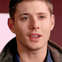 a close up of a man 's face with his tongue sticking out