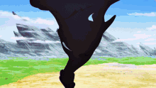 a silhouette of a person standing in the middle of a field with mountains in the background