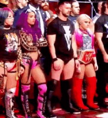 a group of wrestlers are standing next to each other in a row .