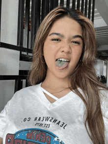 a girl wearing a white shirt that says ' denim ' on it