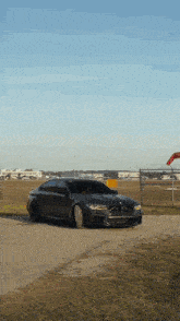 a black car is parked in a parking lot