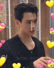 a man with hearts around him and the word bebi on the bottom right