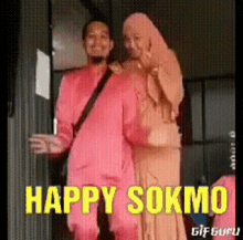a man and a woman are standing next to each other and the words happy sokmo are on the bottom of the image .