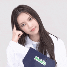 a woman in a lab coat holds a folder that says melon on it