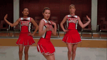 three cheerleaders wearing wmhs uniforms are dancing