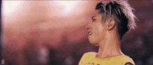 a man in a yellow shirt with the letter d on the bottom right