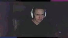 a man wearing headphones is sitting in front of a computer .