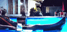a man is laying in a swimming pool with a radio and a cup of milk