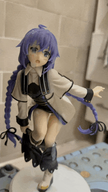 a statue of a girl with purple hair is standing on a table