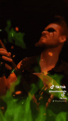 a tiktok video of a man holding a green leaf