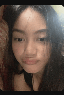 a girl with long hair is making a funny face with her mouth open