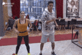 a man and a woman are dancing in a room with playplus written on the bottom of the screen