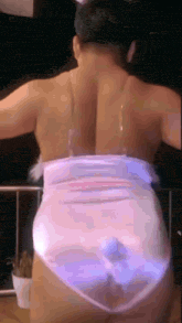 a woman 's back is shown while wearing a purple and white outfit