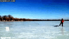 a man is pulling a sled on a frozen lake with senorgif.com in the corner