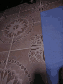 a close up of a tile floor with a floral pattern
