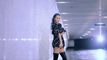 a woman with blue hair wearing a polka dot dress and thigh high boots