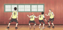 a group of volleyball players are doing a dance together