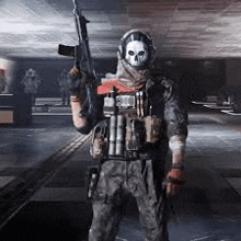 a soldier with a skull mask is holding a gun in a dark room .