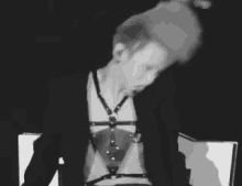 a black and white photo of a man wearing a harness .
