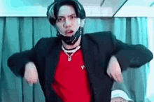 a man wearing a mask and a red shirt is dancing .