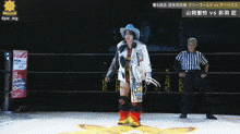 a woman in a cowboy hat is standing in a ring with a referee