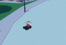 a person is laying on the ground on the sidewalk in front of a building .