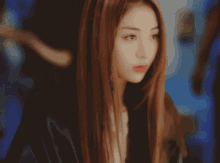a close up of a woman with long brown hair